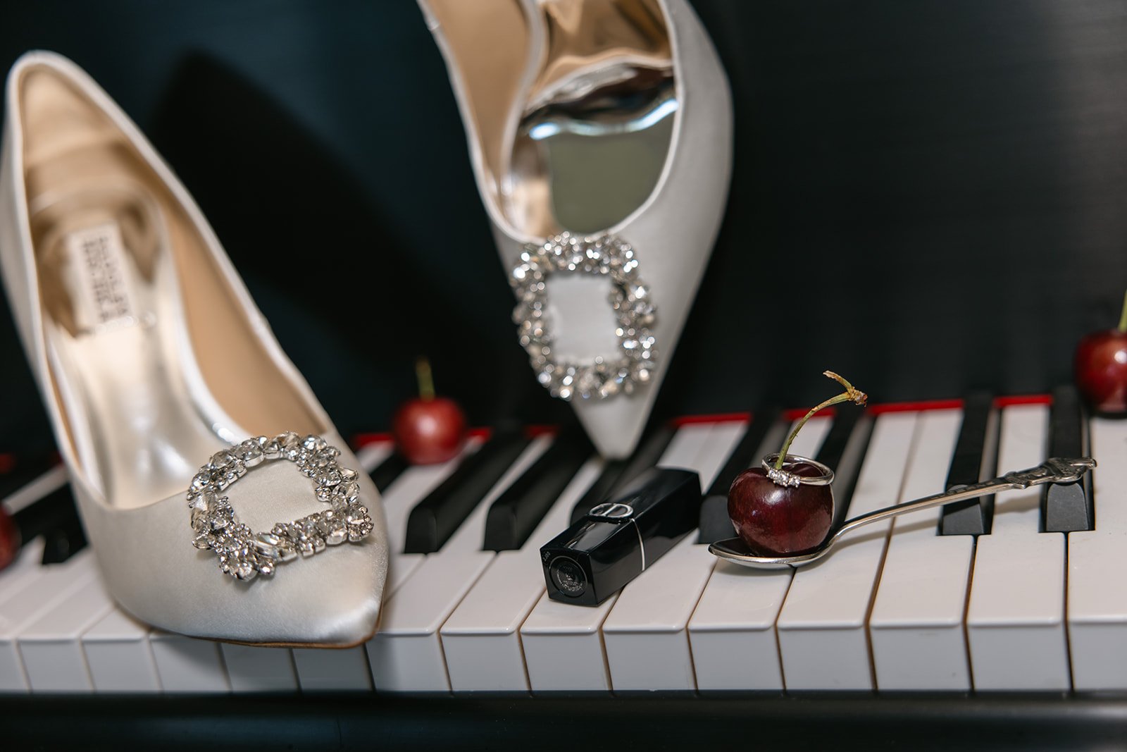 heels on piano keys and the ring on a cherry stem for Wedding Detail Photos