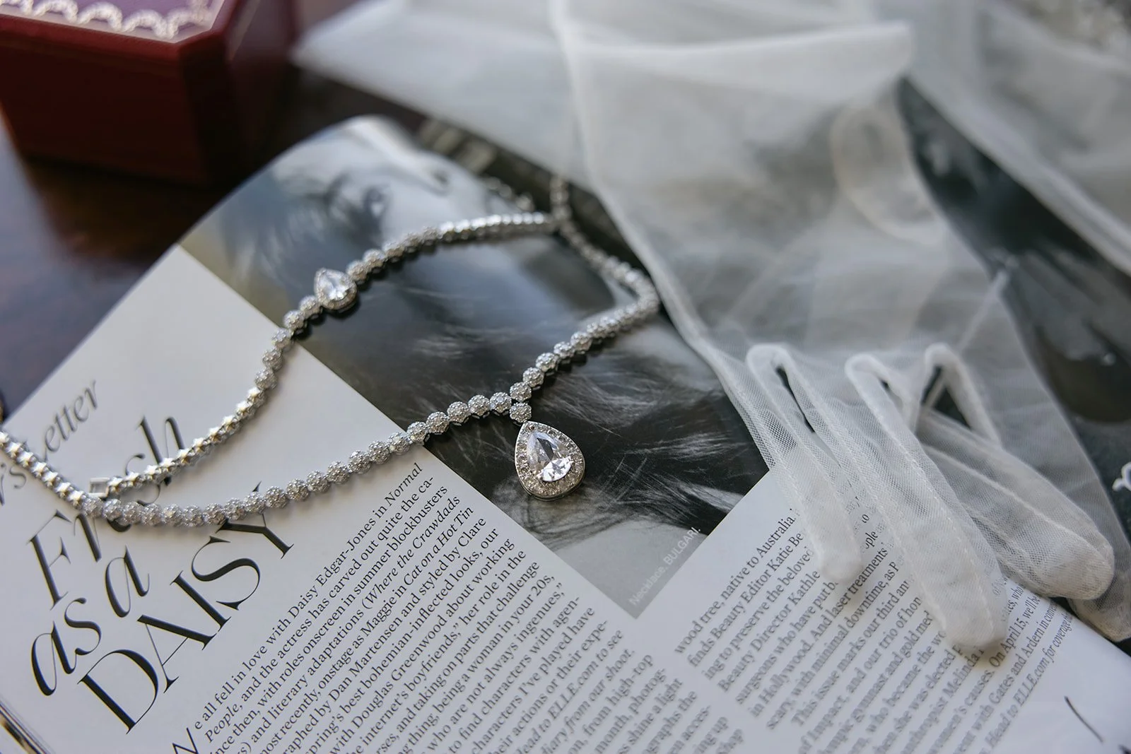bridal gloves and jewelry laid on a magazine for Wedding Detail Photos