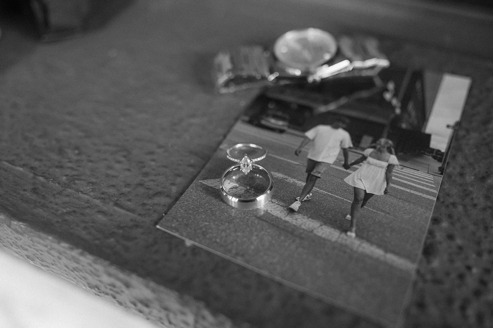 an engagement photo with their rings on top