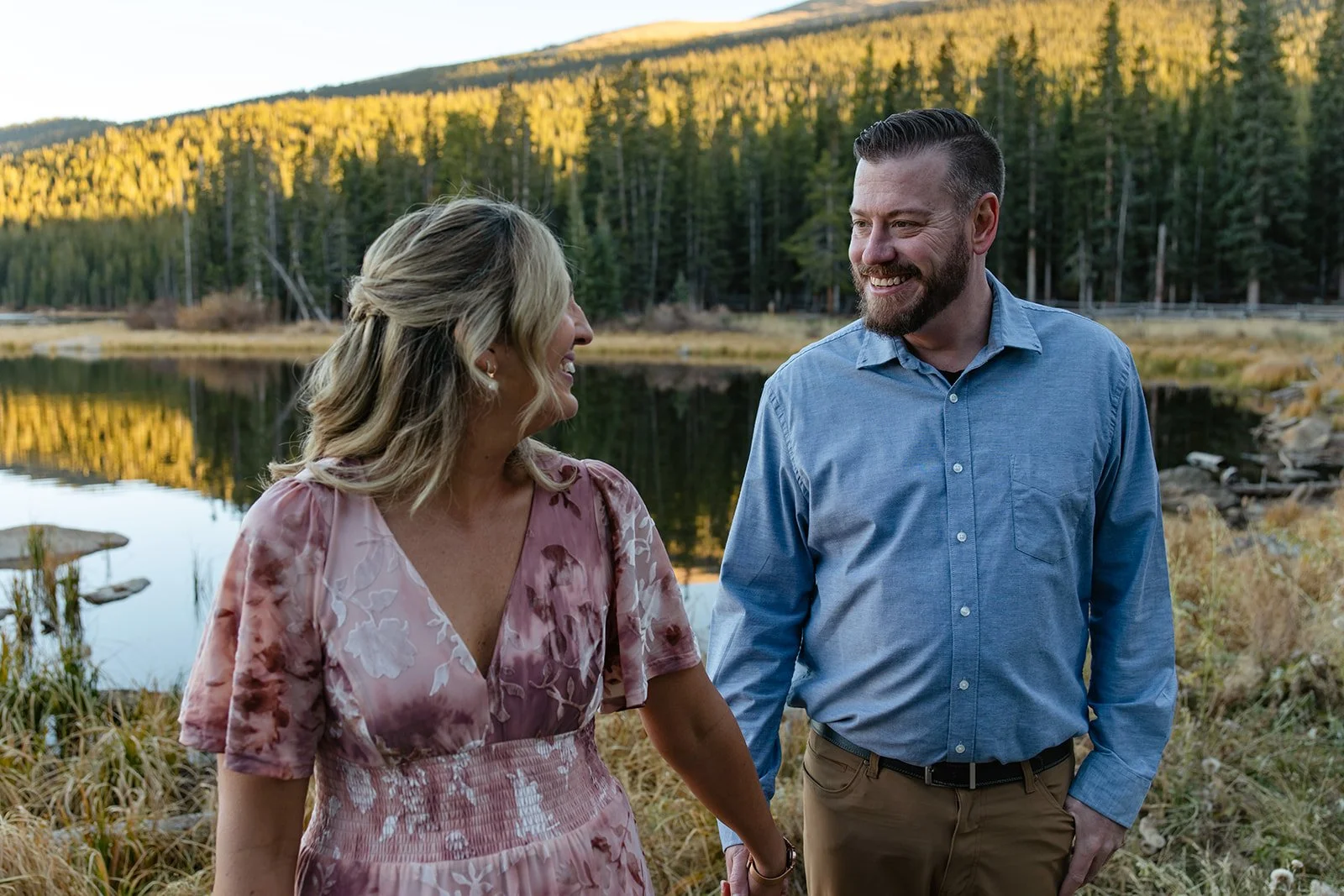 a couple walking around echo lake for their engagement photos in Colorado