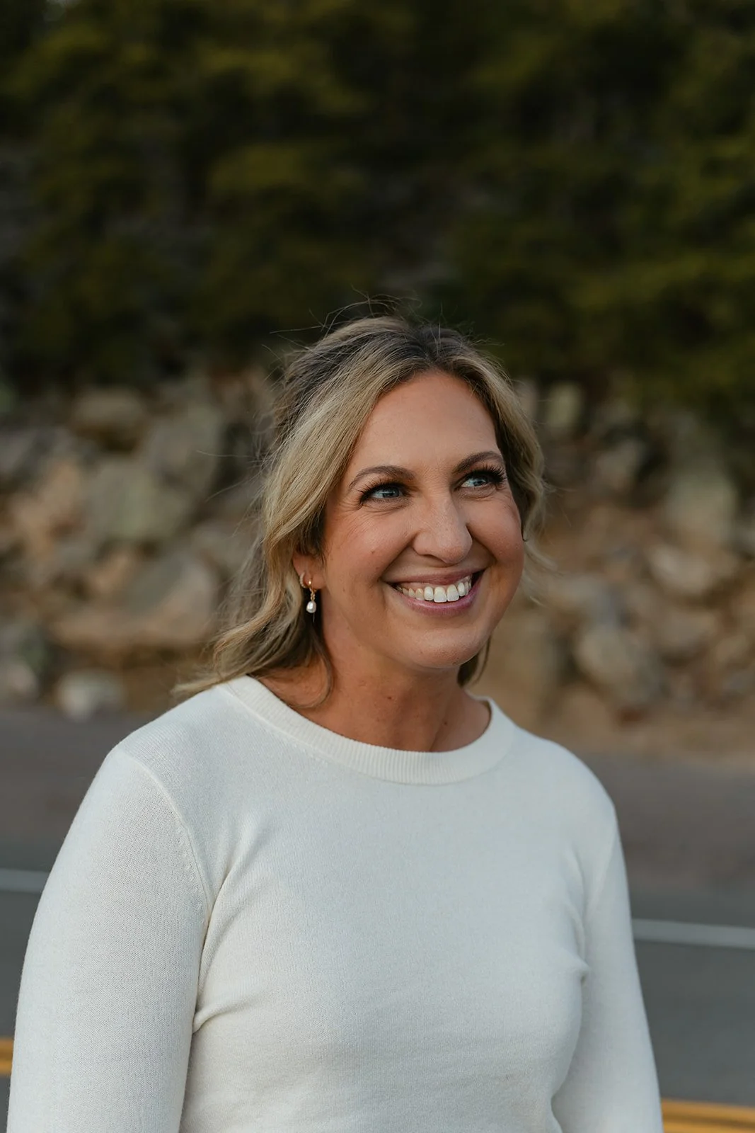 a woman smiling with her makeup professionally done