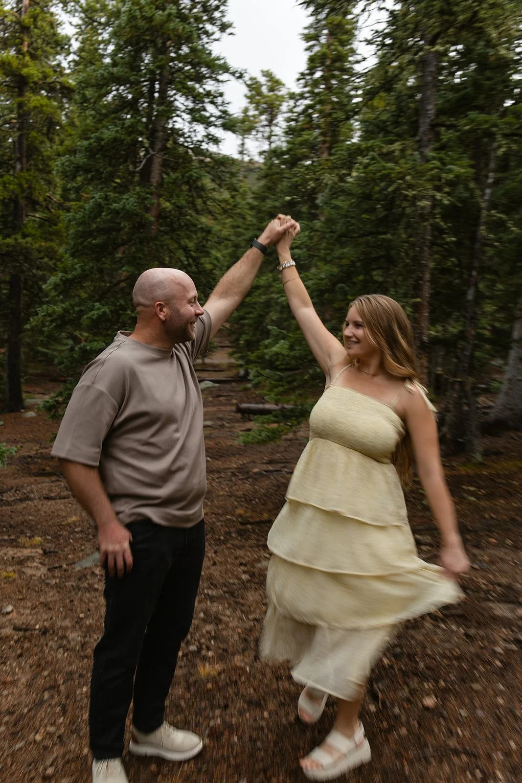 a couple dancing wearing neutral Engagement Photo Outfits