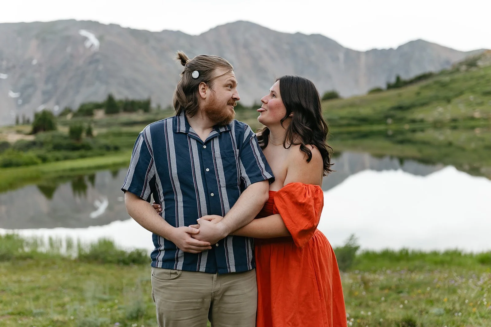 a couple by a mountain lake for their Engagement Photos