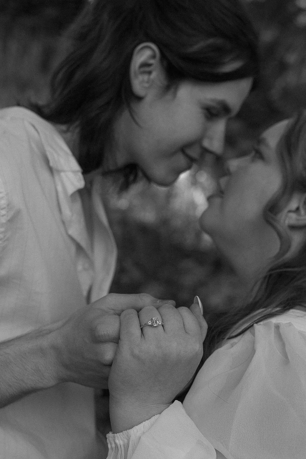 Close up of the couple holding hands and smiling during their Crested Butte elopement, capturing quiet, emotional moments in a forest setting.
