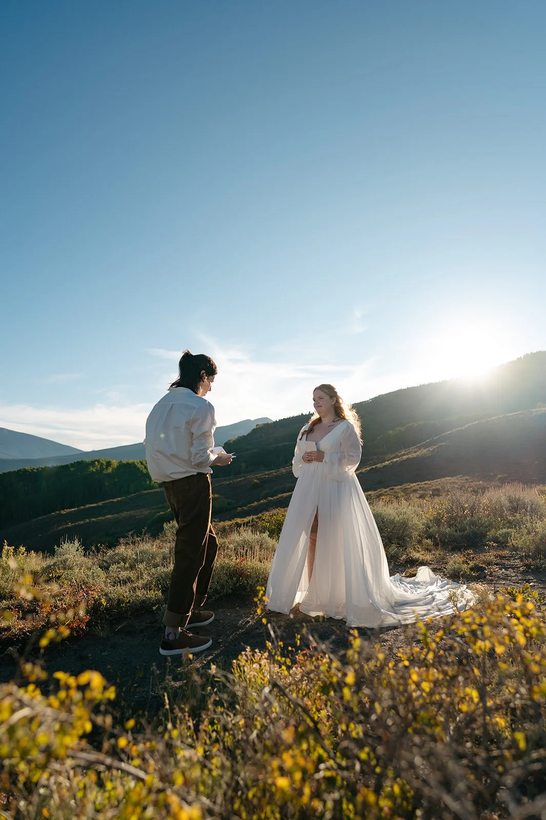 The groom reading his vows to the groom during sunset during their Crested Butte Elopement