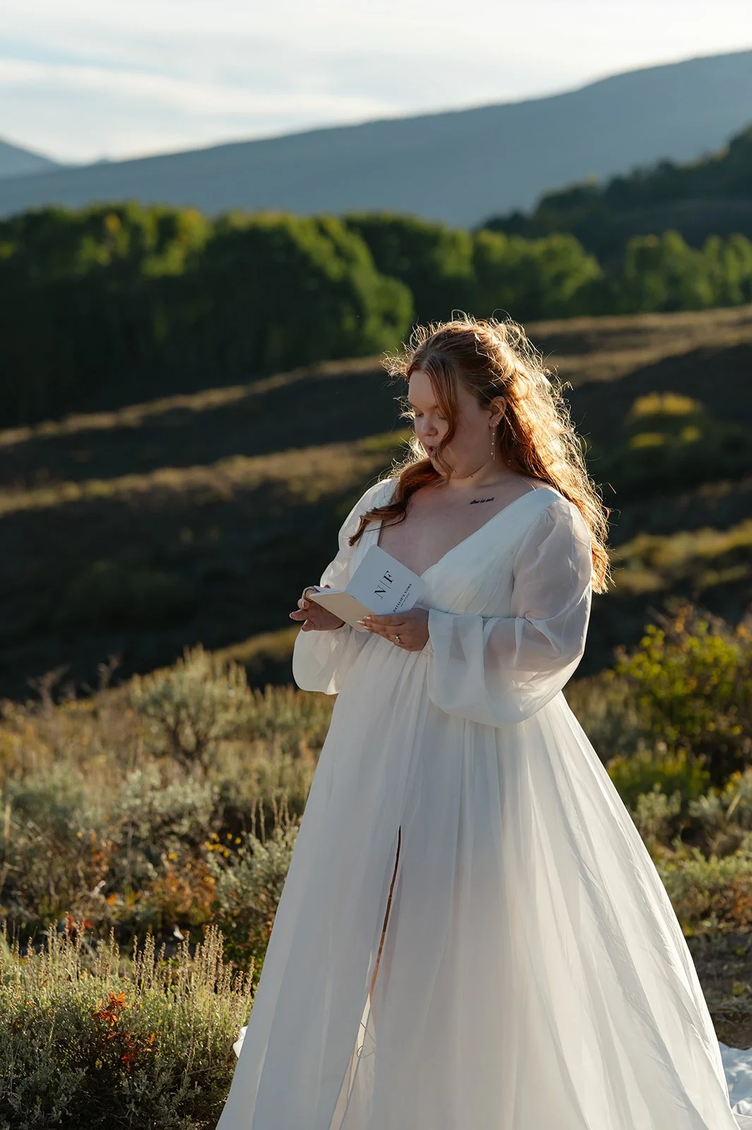 The bride reading her vows to the groom during sunset during their Crested Butte Elopement