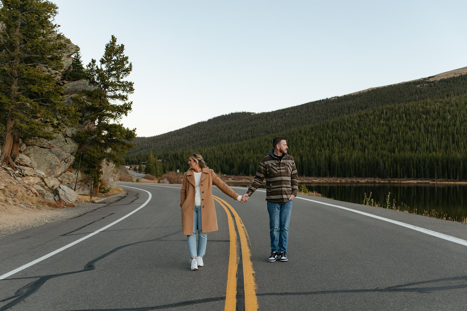 a couple holding hands on a road at echo lake