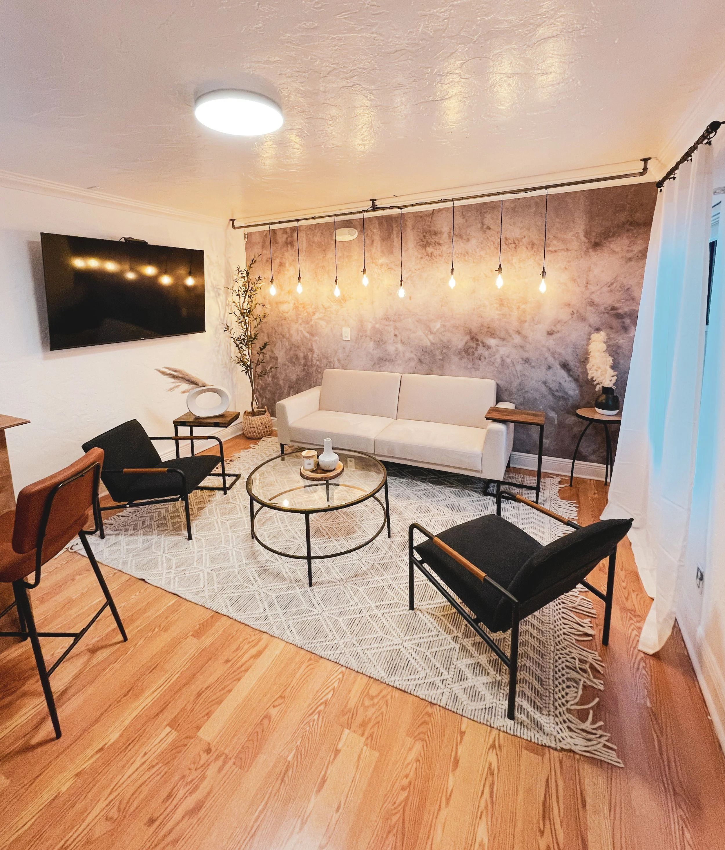 High-end living room designed to reflect the client's personality through intentional layouts, elegant furnishings, and sophisticated residential styling.