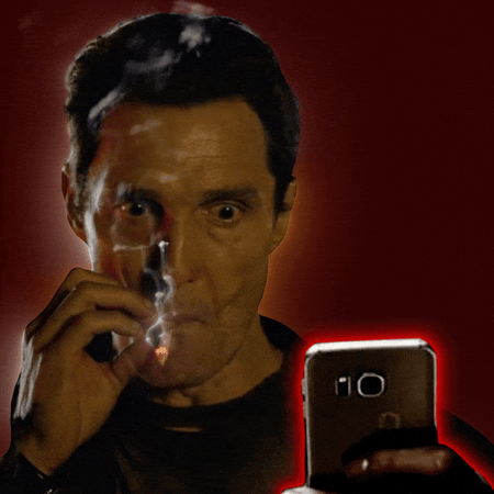 Matthew McConaughey smoking while staring at phone