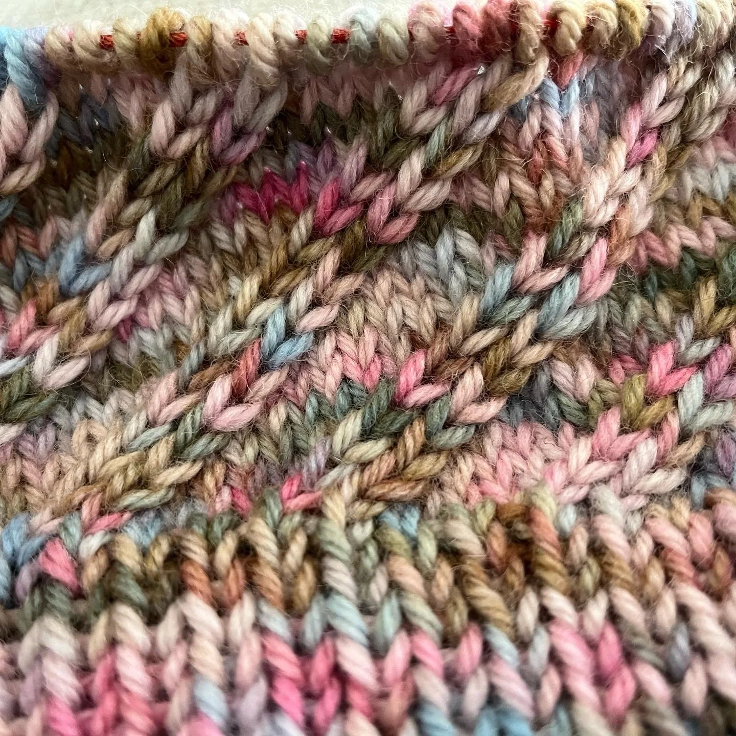 A close up of a knit project knit with multiple colors