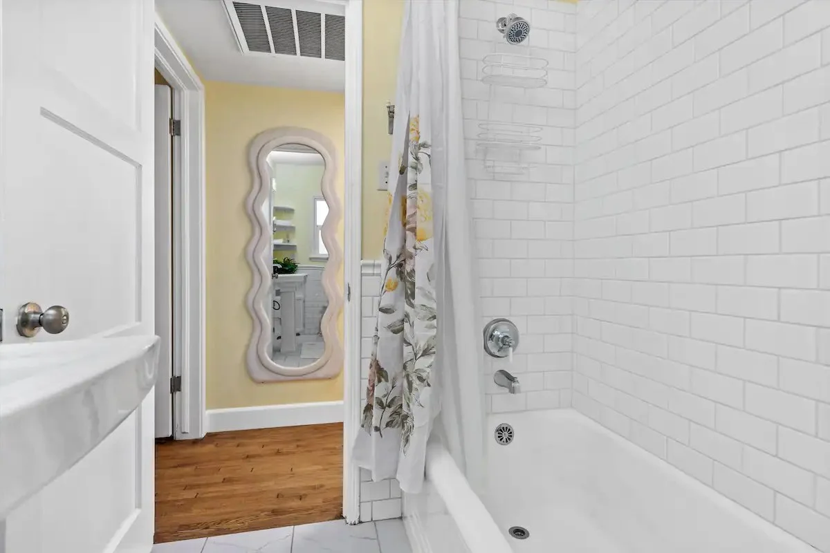 06 Bathroom 1 02 - Bright and Elegant Bathroom with Subway Tile Bathtub and Decorative Mirror.jpg