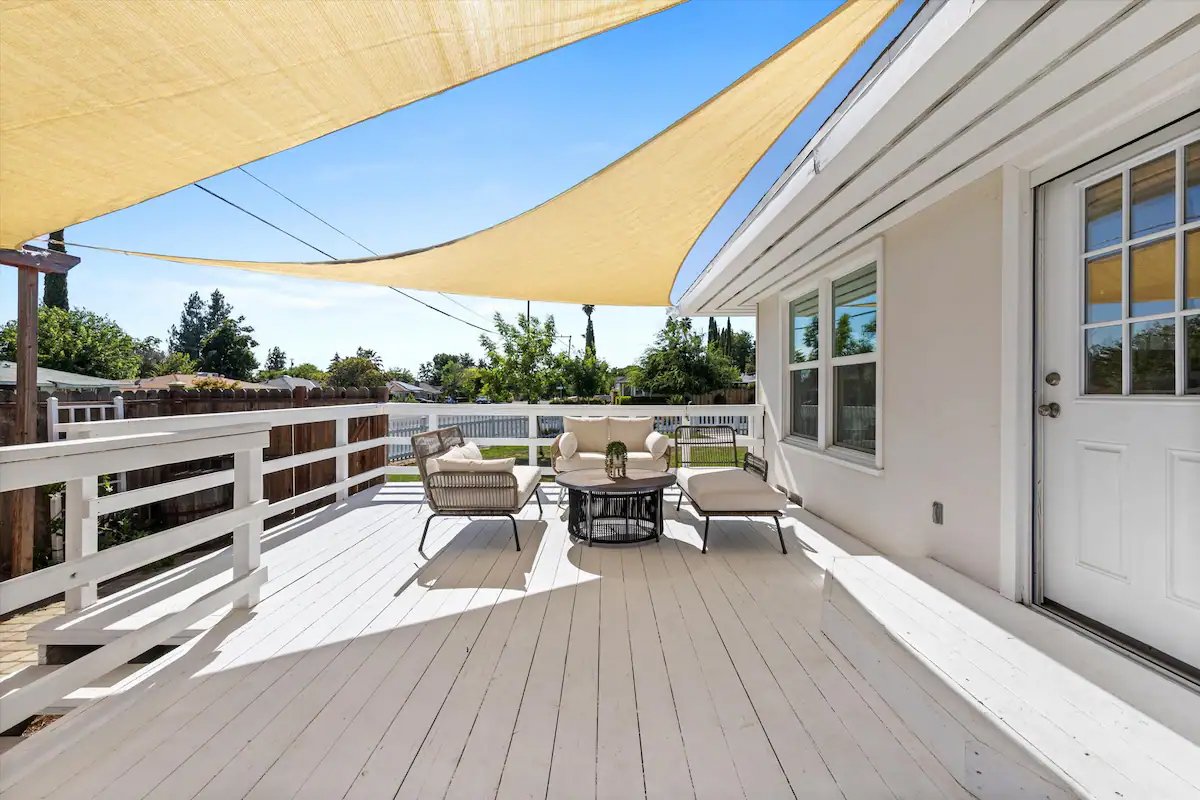 14 Side Patio 01 - Sunny Outdoor Patio with Comfortable Seating and Shade Sails.jpg