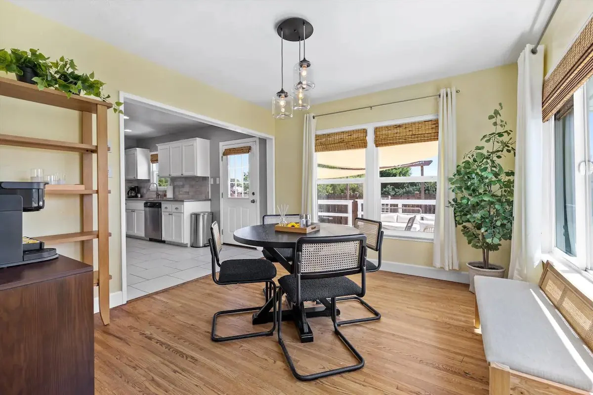 08 Dining Room 01 - Charming Dining Area with Natural Light and Modern Decor.jpg
