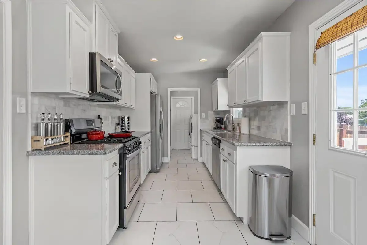 09 Kitchen 01 - Modern White Kitchen with Stainless Steel Appliances.jpg