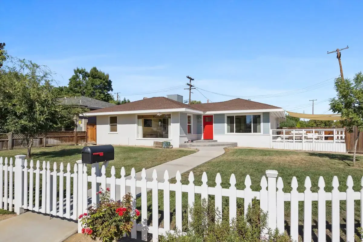 01 Front Area - Charming Single-Story Home with Red Door and White Picket Fence.jpg
