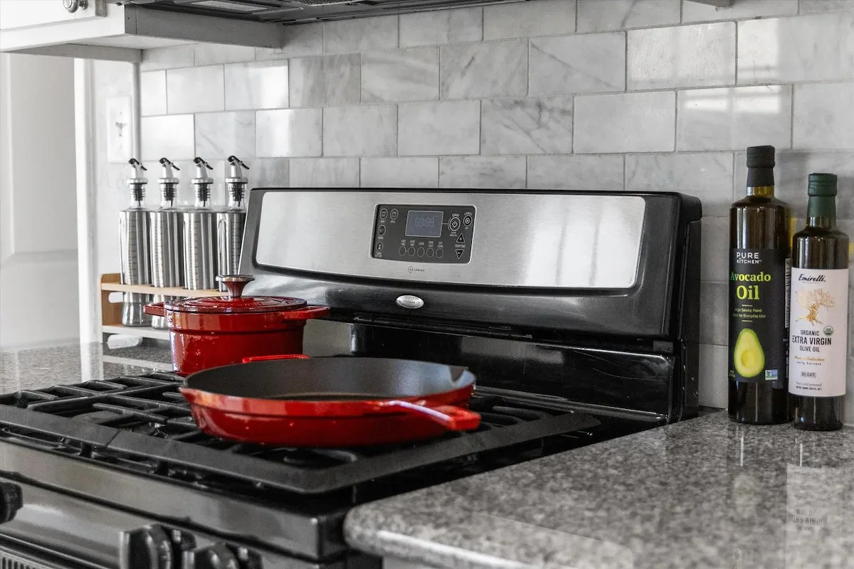 09 Kitchen 10 - Modern Kitchen with Stainless Steel Stove and Red Cookware.jpg