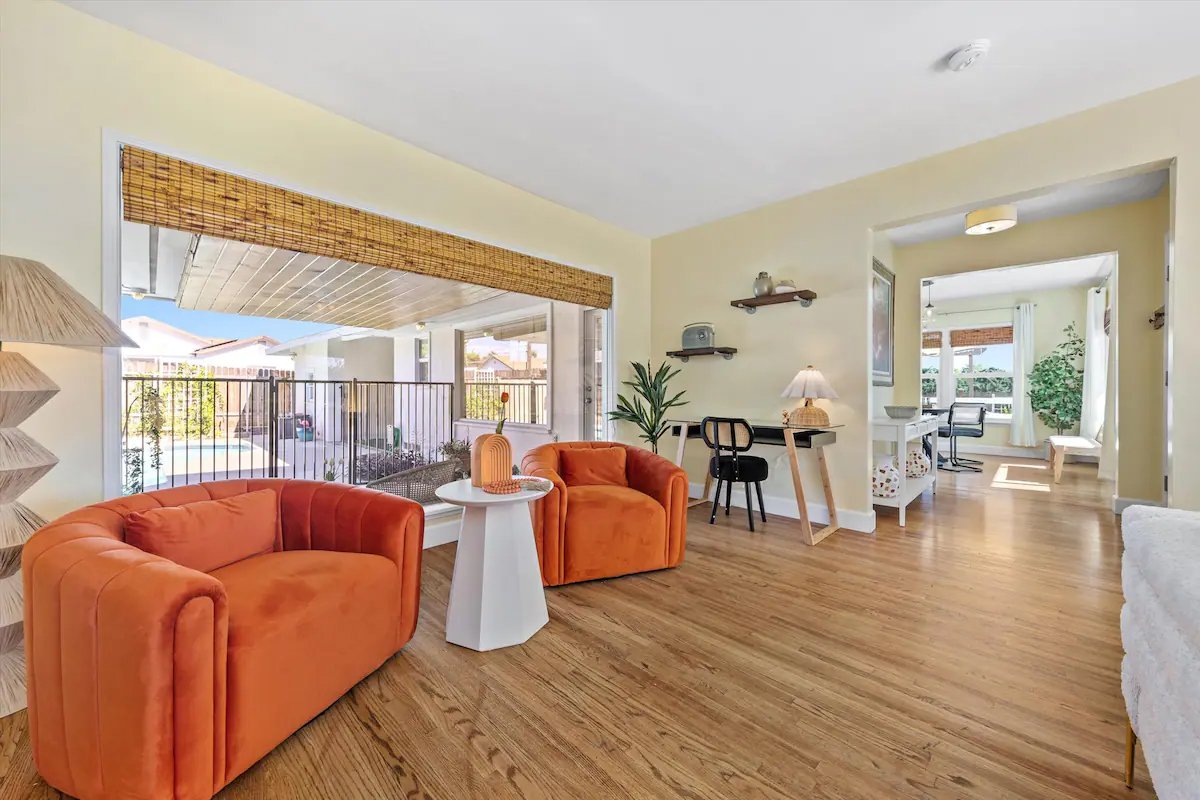 07 Seating Area 01 - Bright and Inviting Living Area with Pool View and Cozy Seating.jpg