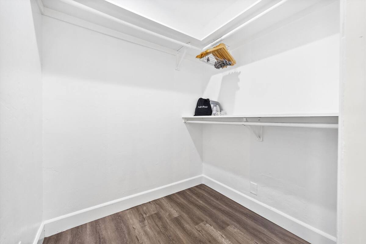 11 PRIMARY Bedroom 03 - Spacious Walk-In Closet with Shelving and Hangers.jpeg