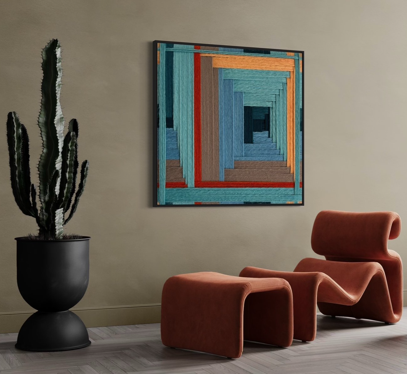 Modern interior with a large potted cactus, colorful abstract wall art, and an orange lounge chair with an ottoman.