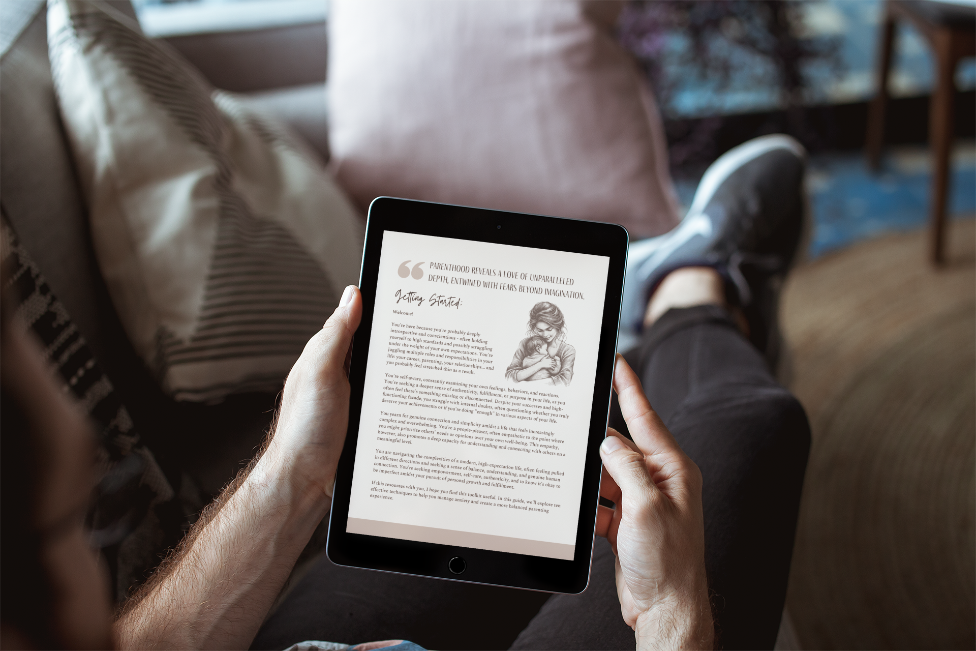 A man sitting on the couch looking at a iPad reading 'Mindful Parent Toolkit.'