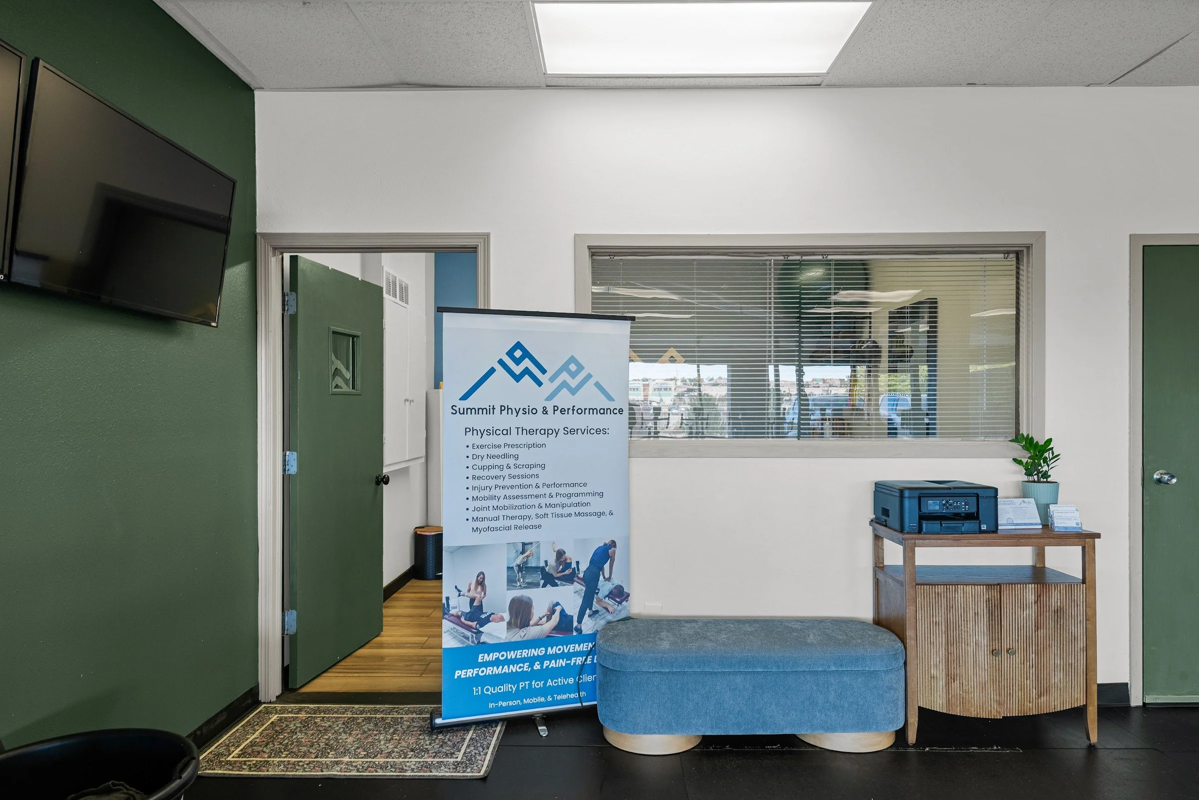 Summit Physio banner and desk in the Mountain Shadows treatment room
