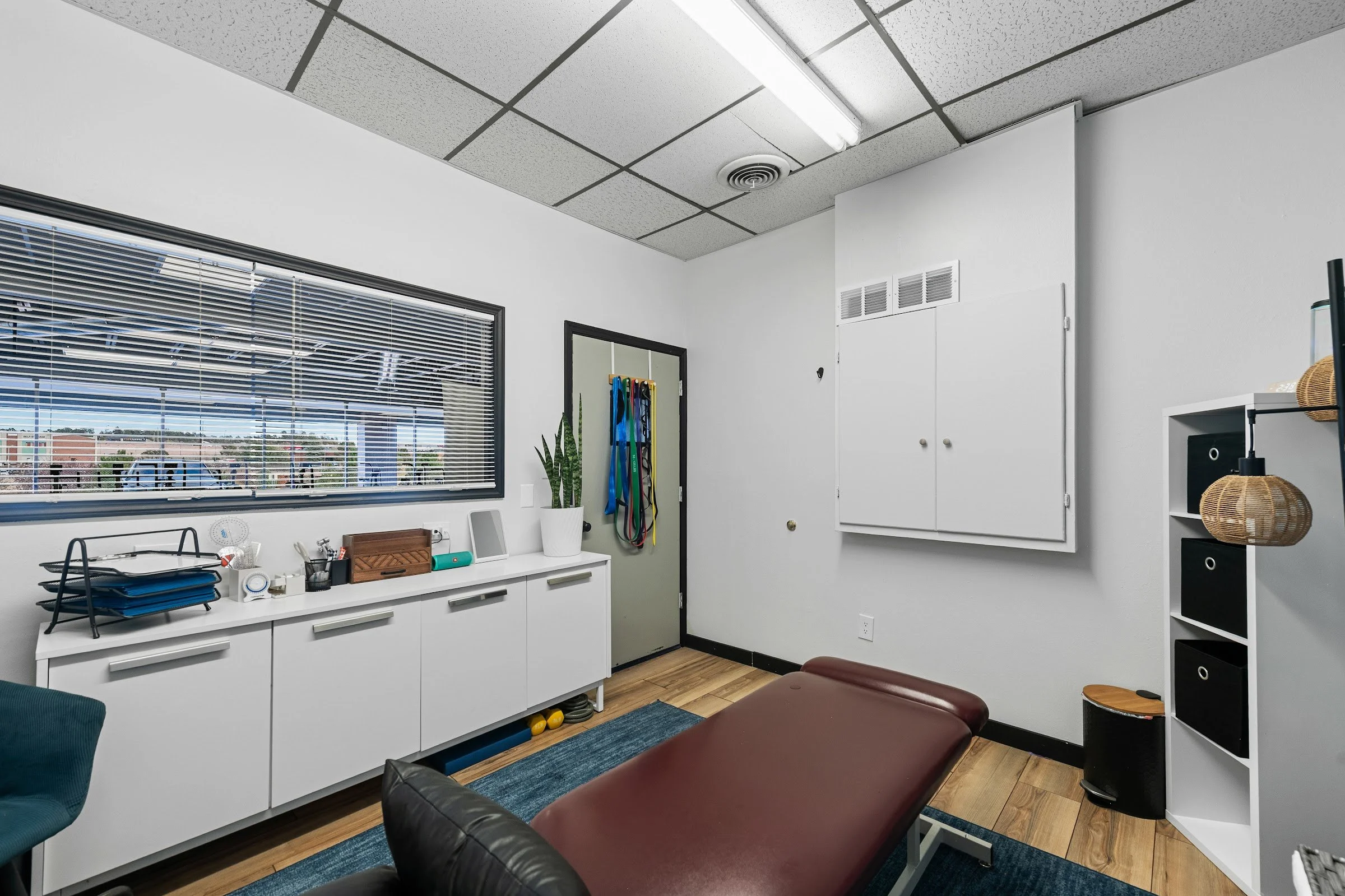 Treatment table and storage cabinets in the Summit Physio satellite room