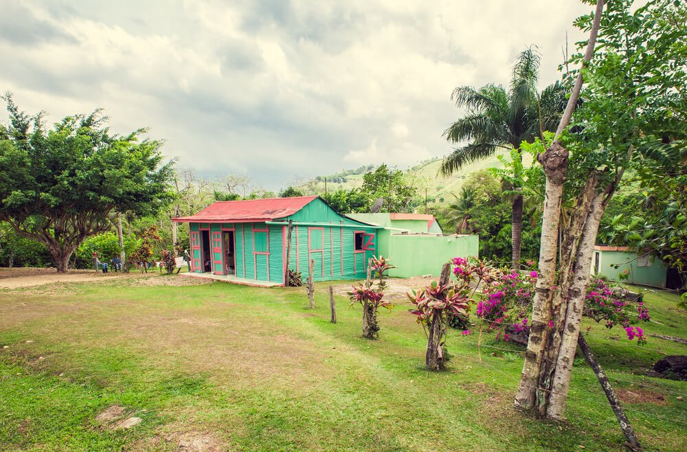 A blue wooden house in the Dominican Countryside. One of the stops on the shore excursion, Dominican Countryside Adventure and Beach Resort.