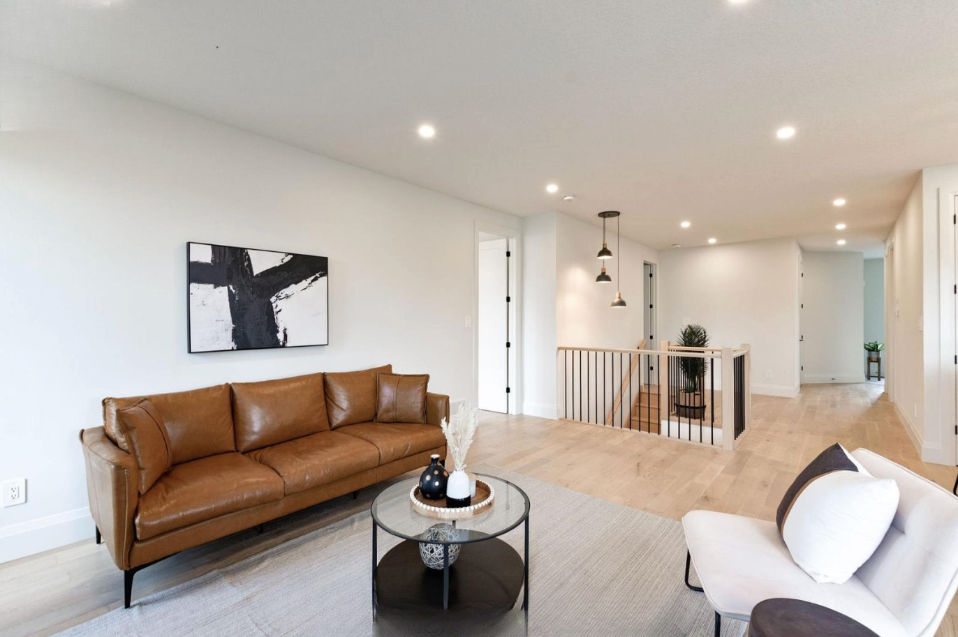 Introducing The Serenity, being built on Lot 11: a luxurious 1-floor bungalow on a 55x128 ft pool-sized lot with a triple car garage, priced at $939,900. This open-concept home features a designer kitchen, great room with gas fireplace, master suite 