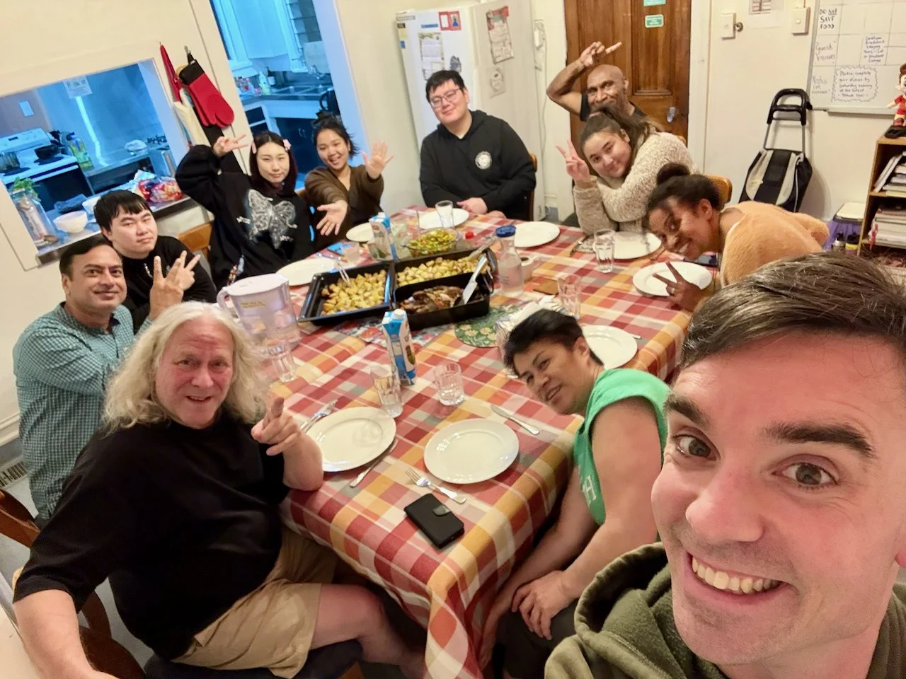 A photo of a Kia Maia community dinner and lots of happy people having fun together