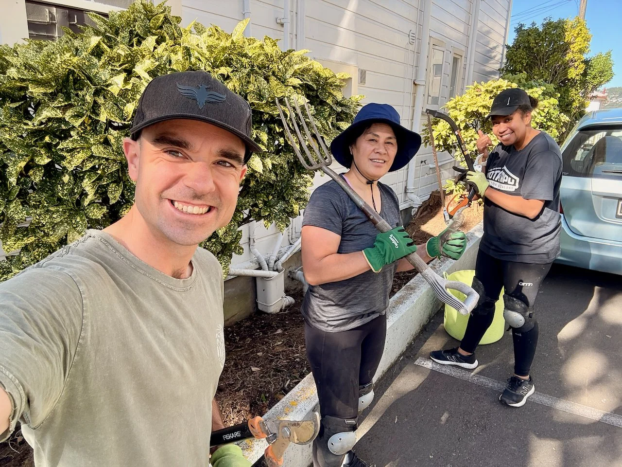 A Photo of the three Kia Maia Wardens, Miliana, Naomi and Tim, in the garden