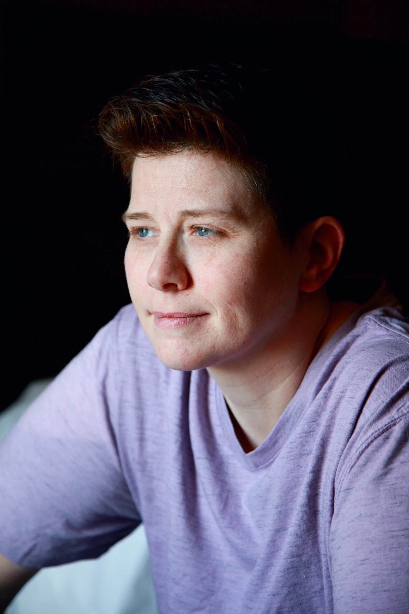 A person looking thoughtfully to the left