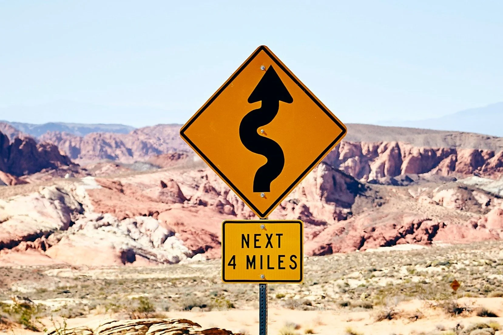 A road sign indicating a windy road ahead