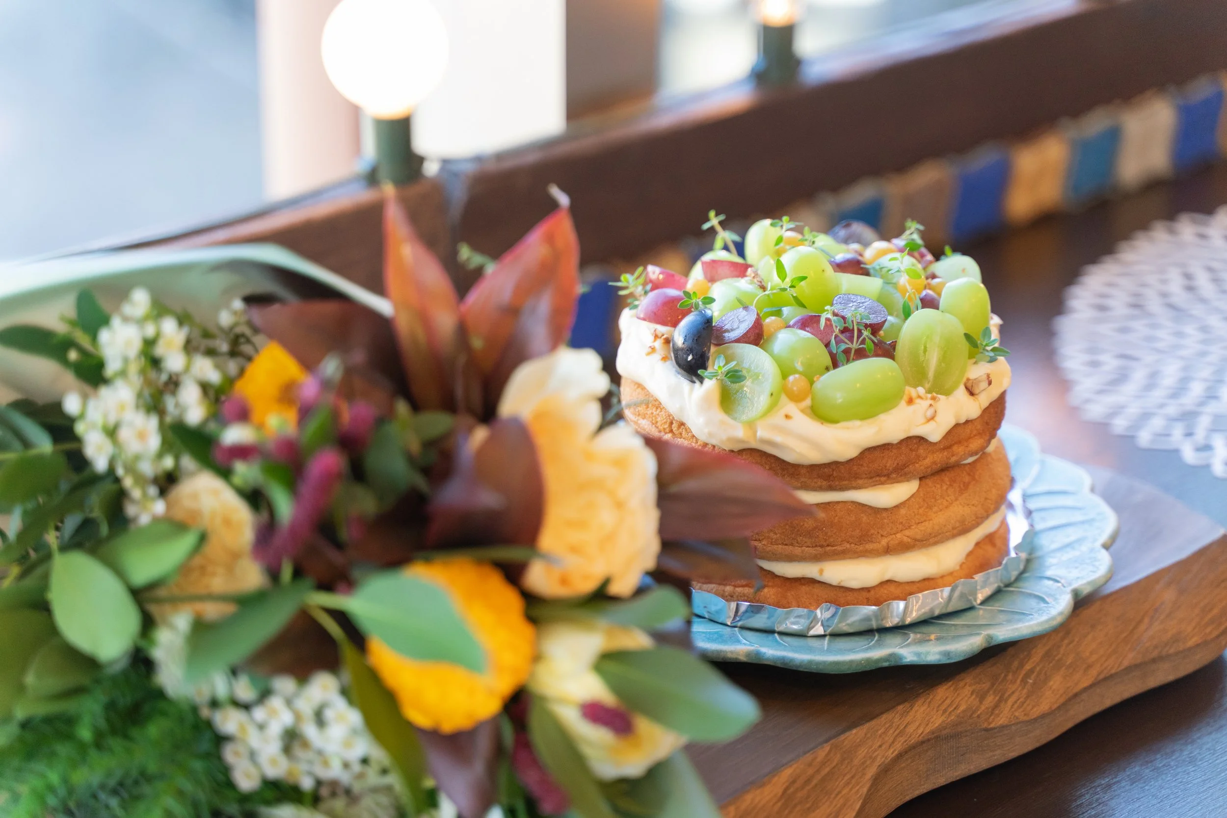 A set of a seasonal flower bouquet and a grape anniversary cake