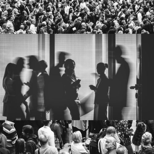 Three groups of people in a crowded indoor setting, possibly a queue or waiting area, with silhouettes of individuals using smartphones or interacting.