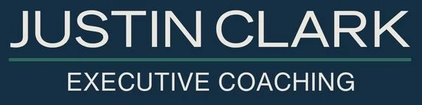 Business card for Justin Clark, Executive Coaching, with a dark background and white text.