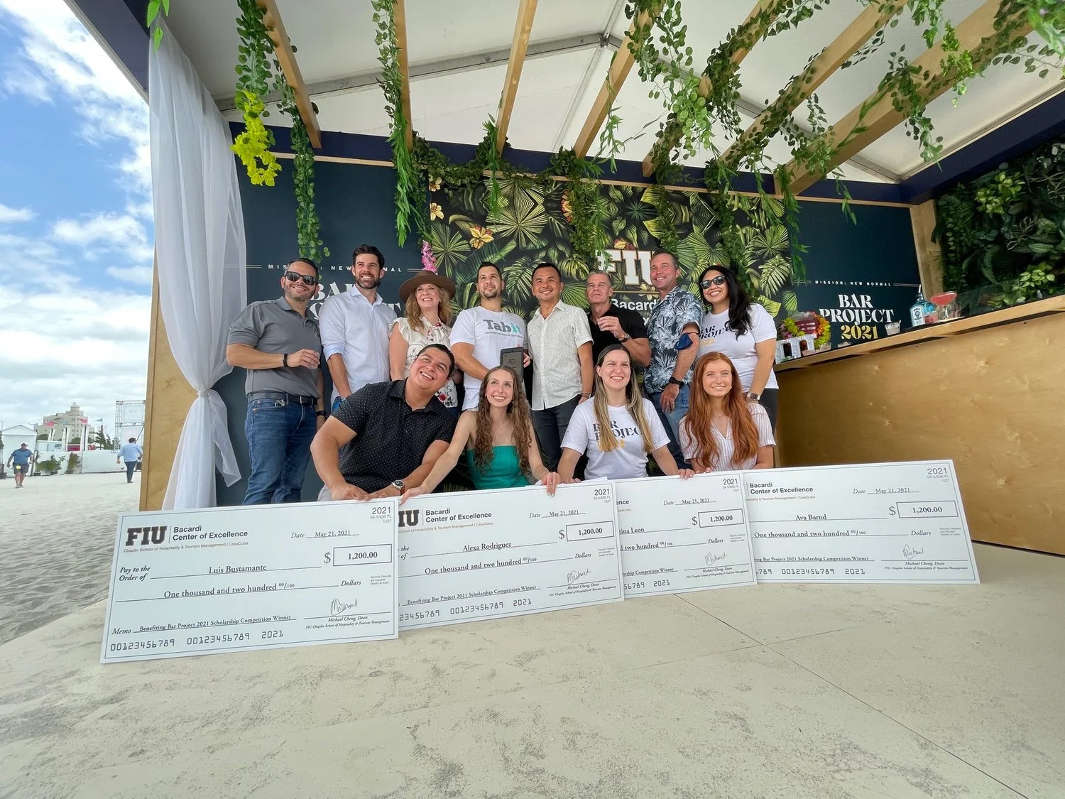 A group of people posing in front of a large check.