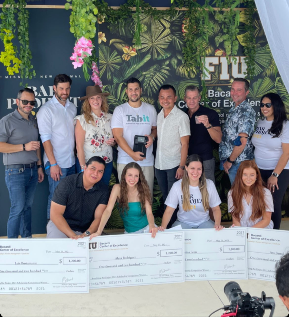 A group of people posing with checks.