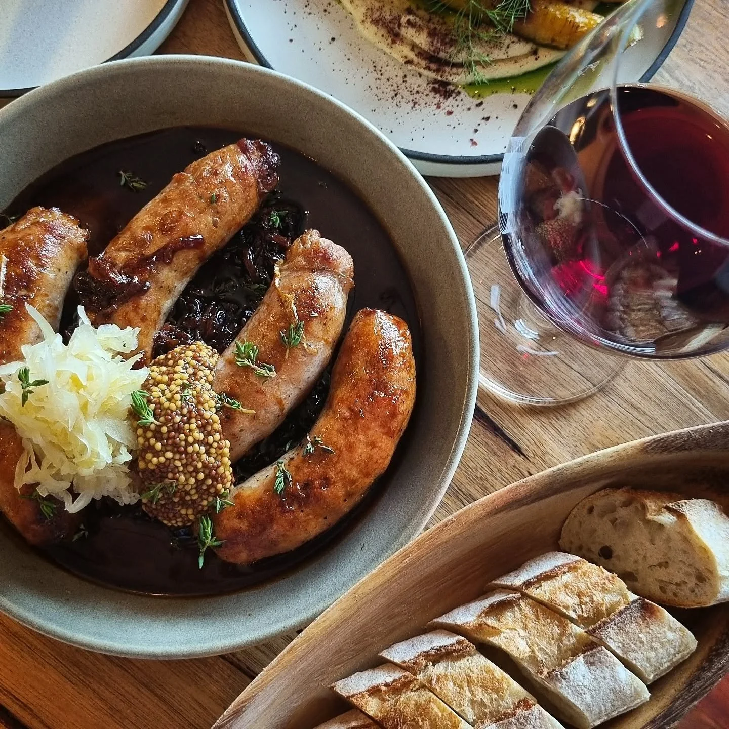 Comfort food, wine bar style 🍷

Ft. Pork &amp; fennel sausages, sauerkraut, mustard, roasted carrots with tahini, fresh bread and of course a glass of red.