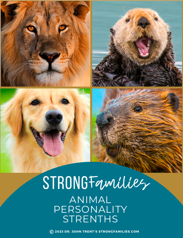 A young girl kneeling on a wooden platform and pressing her hand against glass at a zoo, watching a lion cub lying with its head down close to the glass. Another girl with curly hair stands behind her.