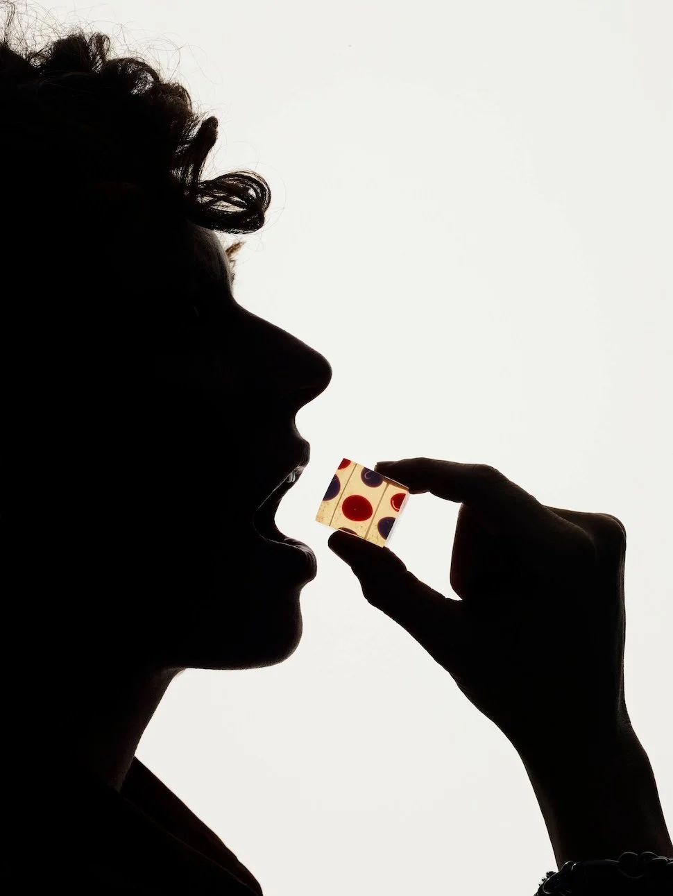 Silhouette of a person enjoying a Solid Wiggles jelly shot.