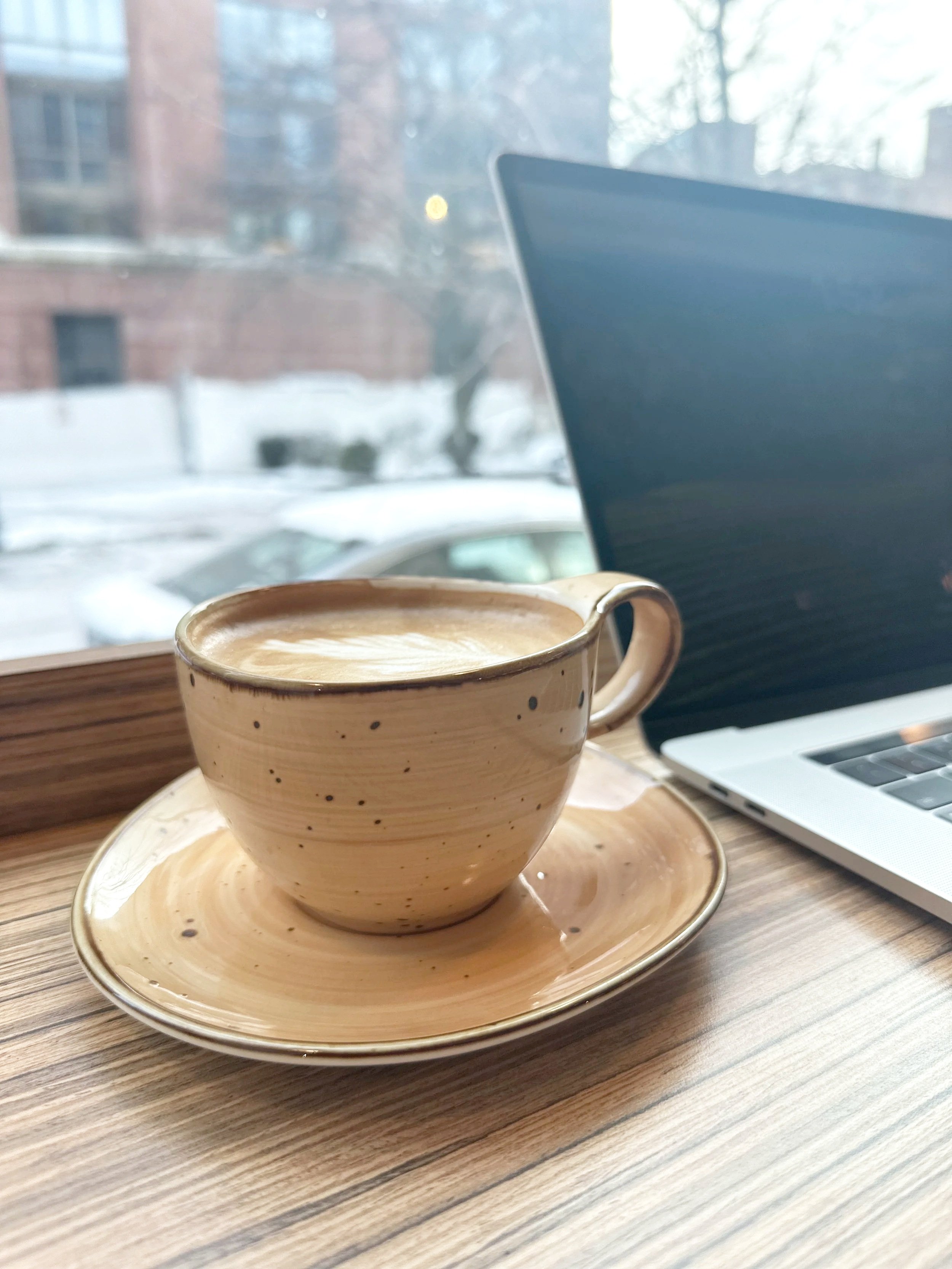 Ashlee Espinosa sitting by a firepit in activewear, reflecting and recharging in a peaceful outdoor setting.
