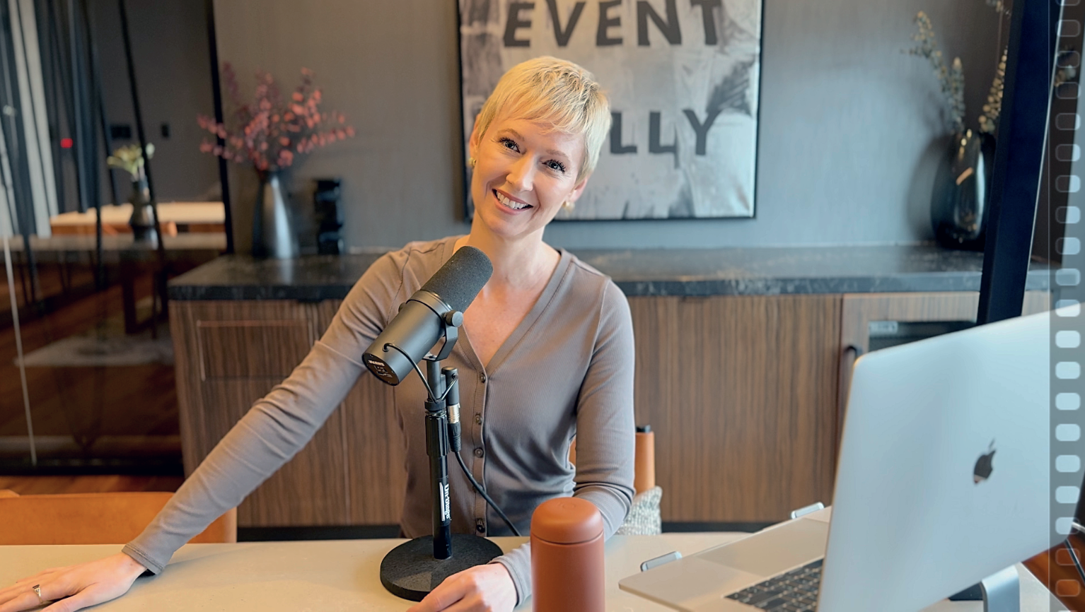 Ashlee Lynn Espinosa sitting confidently in a neutral-toned dress beneath an architectural structure, symbolizing career clarity and strength.