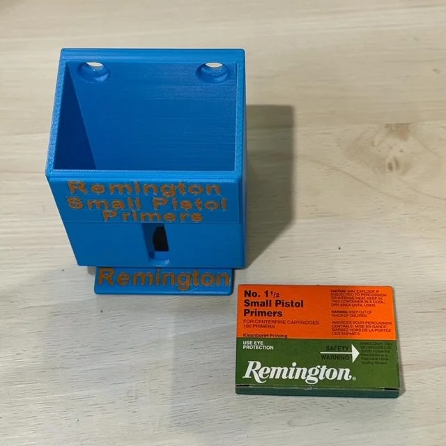 Remington primer pack organizer resting on light surface, waiting to hold and dispense primer packs.