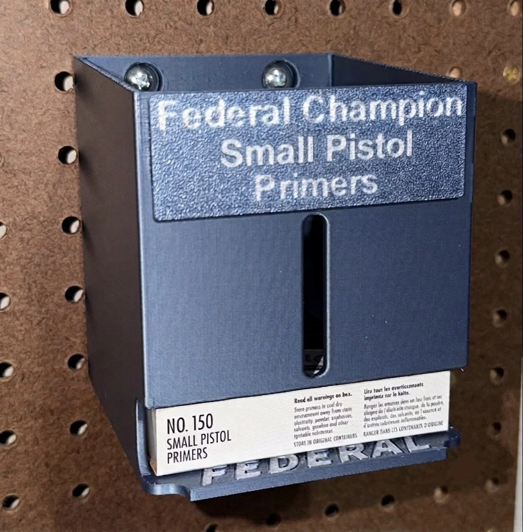 Federal Champion Small Pistol Primer Pack Organizer mounted on a pegboard for reloading bench storage.