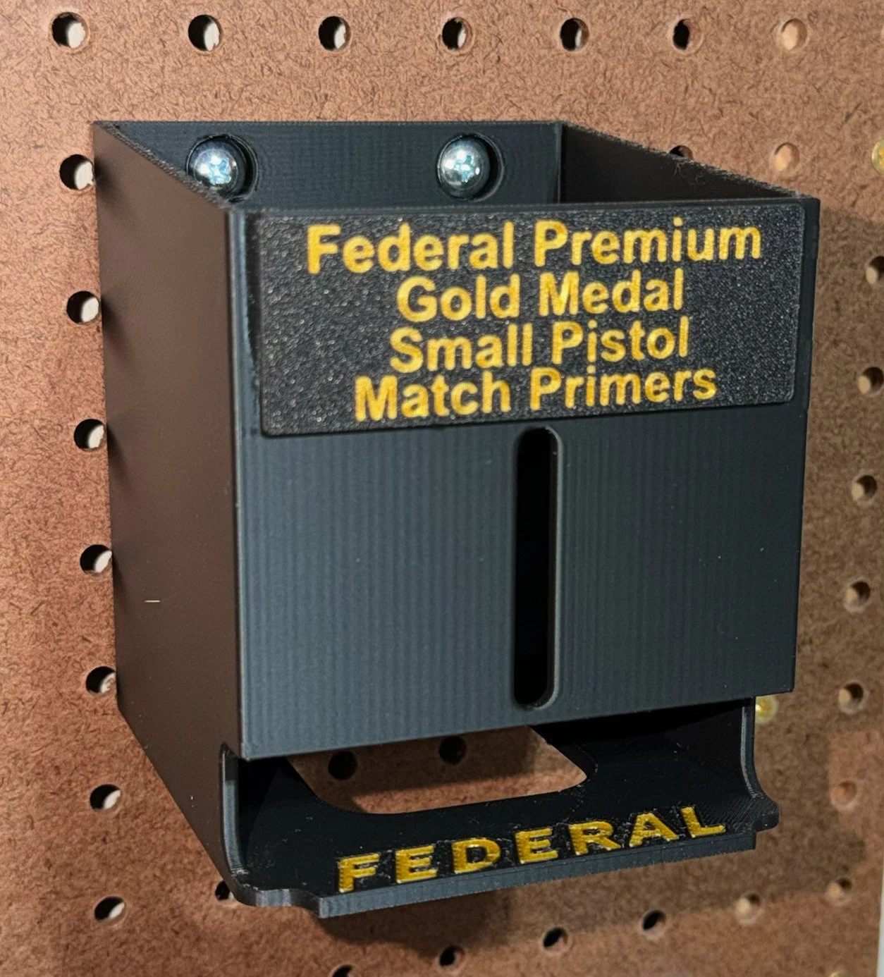 Pegboard‑mounted organizer for Federal small pistol match primer packs.