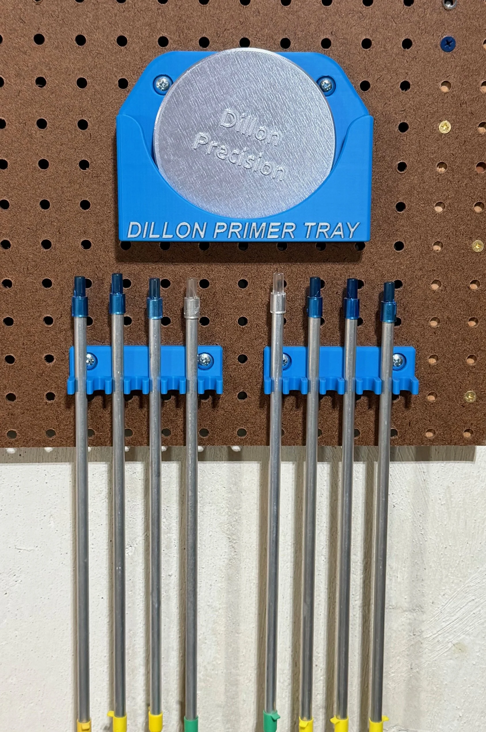 Primer tray and pickup tube holder set mounted on a pegboard, showing the dedicated tray holder and two vertical tube holders designed for Dillon reloading tools.