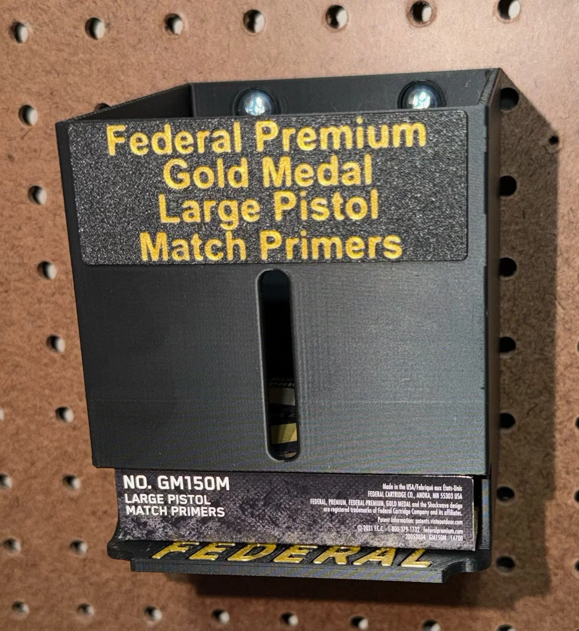 Large pistol match primer pack organizer mounted on a pegboard with Federal primer packs.