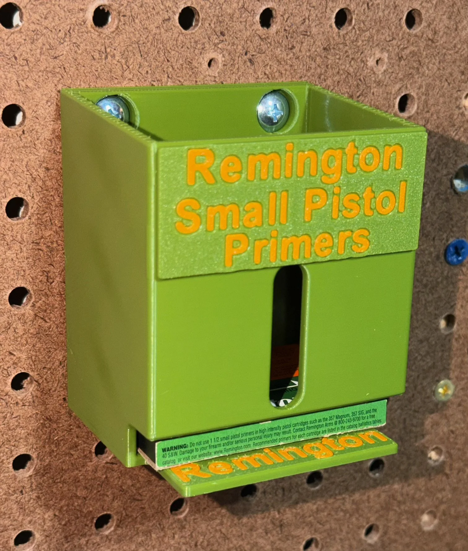 Remington Small Pistol Primer Pack Organizer mounted on a pegboard, holding one No. 1 1/2 primer pack.