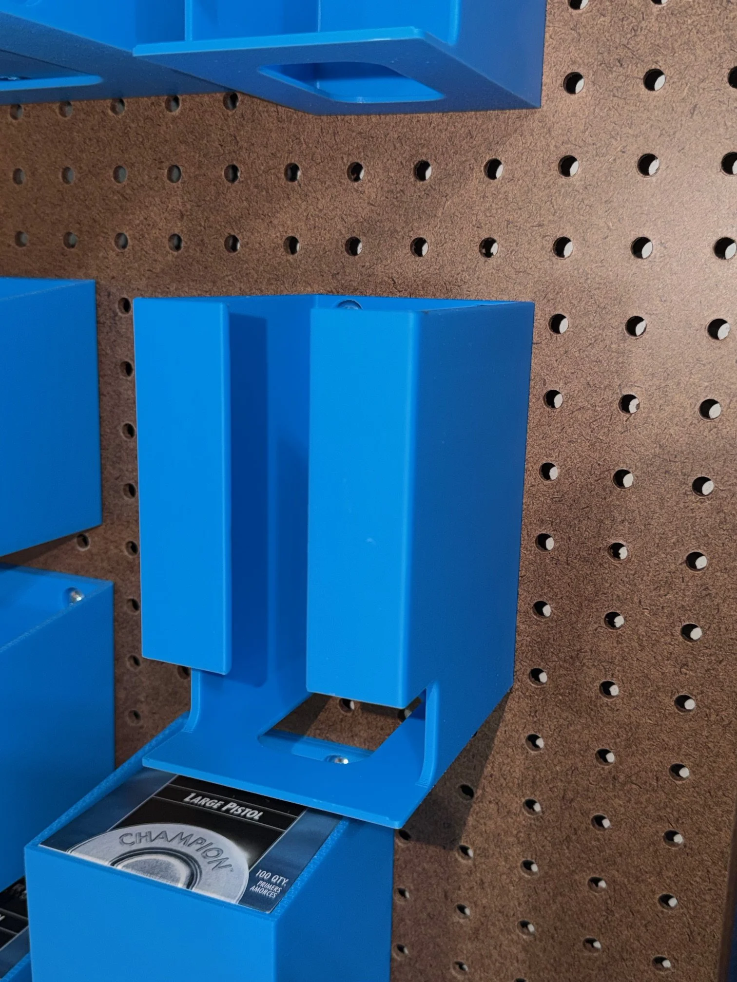 An empty Dillon 550 Caliber Conversion 5 Kit Holder mounted on pegboard.