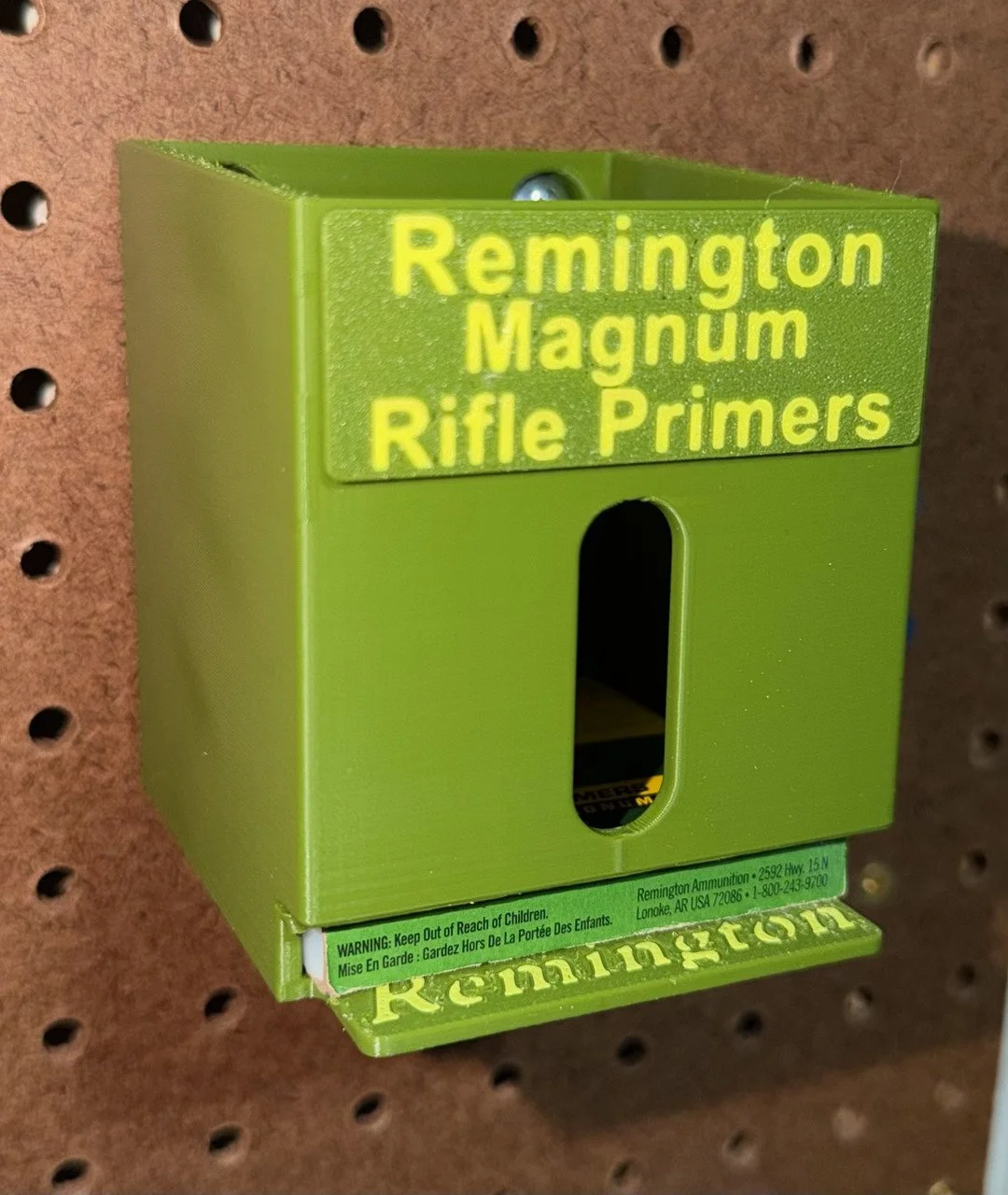 Remington No. 9 1/2 Magnum Rifle primer pack organizer mounted on a pegboard and holding one primer pack.